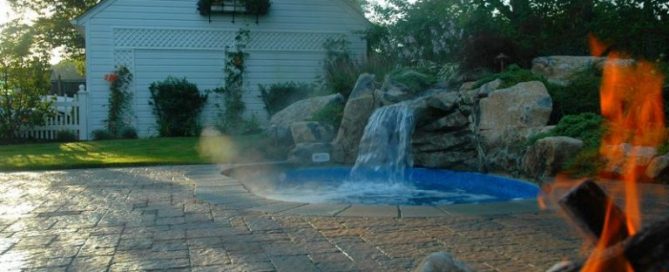 “After” Landscaping Second angle of “after” job complete. Here you can see the garage, fence, patio and spool; you can almost feel the warmth from their natural gas campfire. The end result is a beautiful backyard oasis tucked nicely into a corner of their new backyard upgrade.